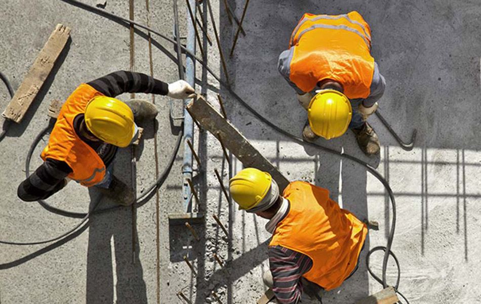 Premium Concrete crew setting formwork and rebar on a commercial slab